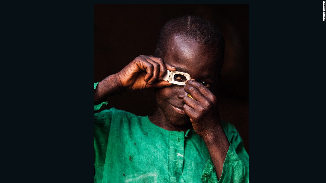 Mustafa (photographer) Central African Republic. Mustafa poses dressed up as how he sees himself in the future, as a photographer, Central African Republic