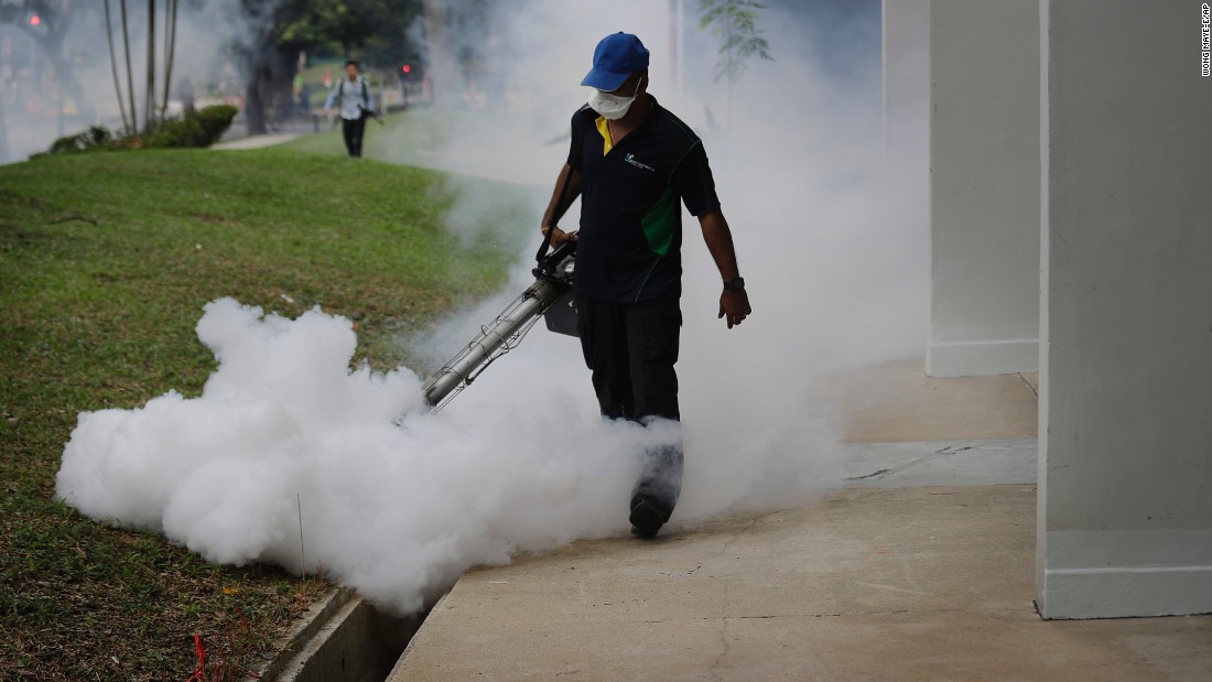 A pest control worker fumigates drains at a local housing estate where the latest case of Zika infections were reported on Thursday, September 1, in Singapore. 