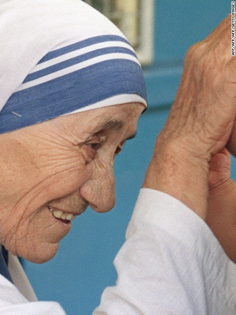 Mother Teresa (L) gives her blessing to a child at the Gift of Love Home on October 20, 1993, in Singapore. The 1979 Nobel Peace Prize winner is on a stop-over while enroute to China where she will set up a fist home for Chinese handicapped children in Shanghai. AFP PHOTO ROSLAN RAHMAN        (Photo credit should read ROSLAN RAHMAN/AFP/Getty Images)