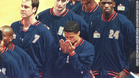 Mahmoud Abdul-Rauf prays during the singing of the national anthem before a Denver Nuggets game in 1996.