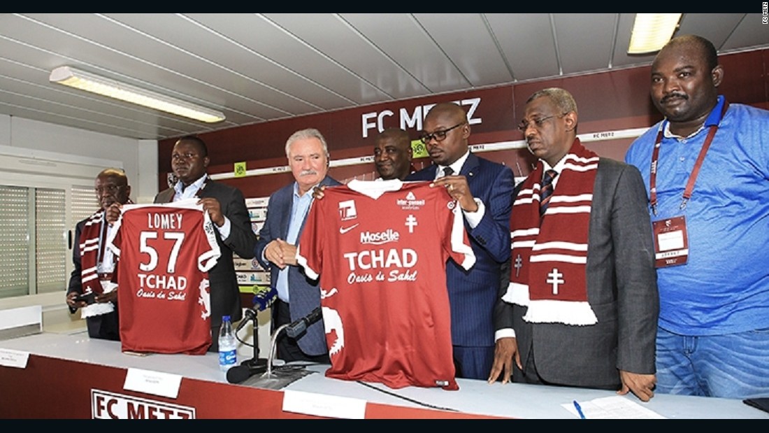 FC Metz President Bernard Serin appears with Chad Minister of Culture, Youth and Sport Betel Miarom to announce the sponsorship agreement, which will see the French club play with &quot;Chad: Oasis of the Sahel&quot; on the team shirts. &lt;br /&gt;&lt;br /&gt;Chadian officials believe the deal will improve their public image and encourage tourism to the Central African state. 