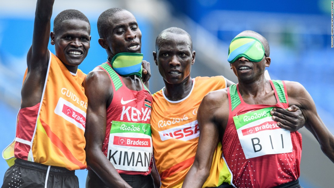 Kenya&#39;s Samwel Kimani (2L) and guide James Boit (L) got the medal procession under way in Rio, winning the first gold of the Paralympic Games in the men&#39;s T11 5,000m.