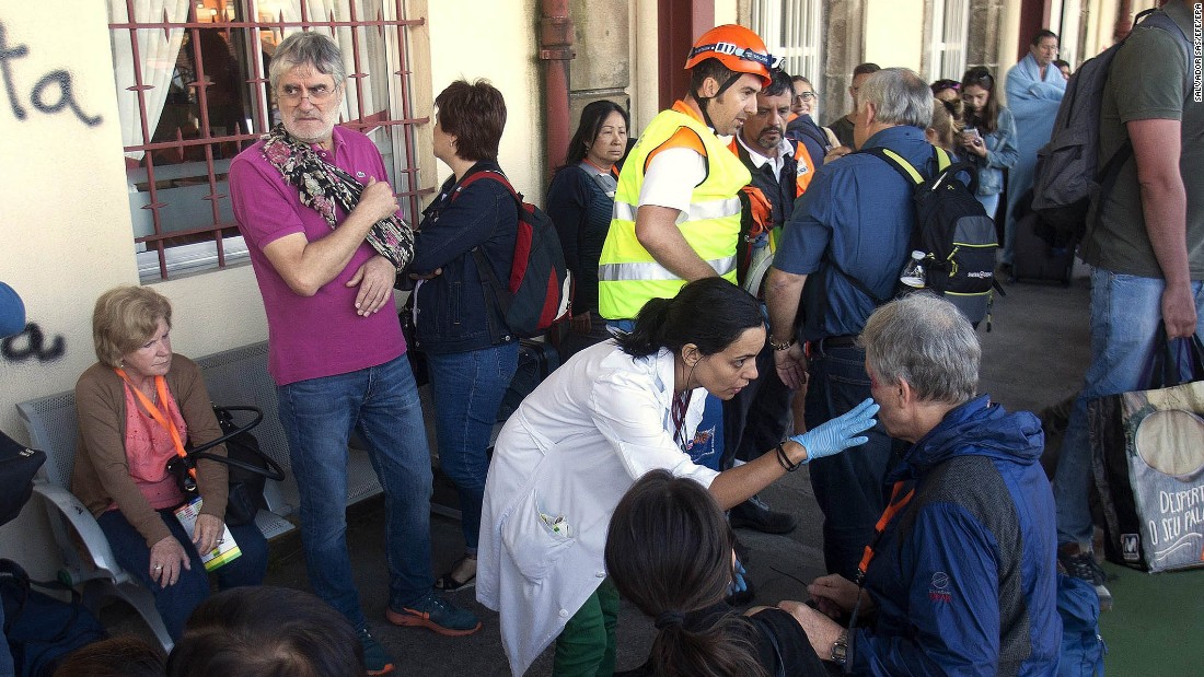 Spanish emergency service workers tend to injured passengers near O Porrino. 