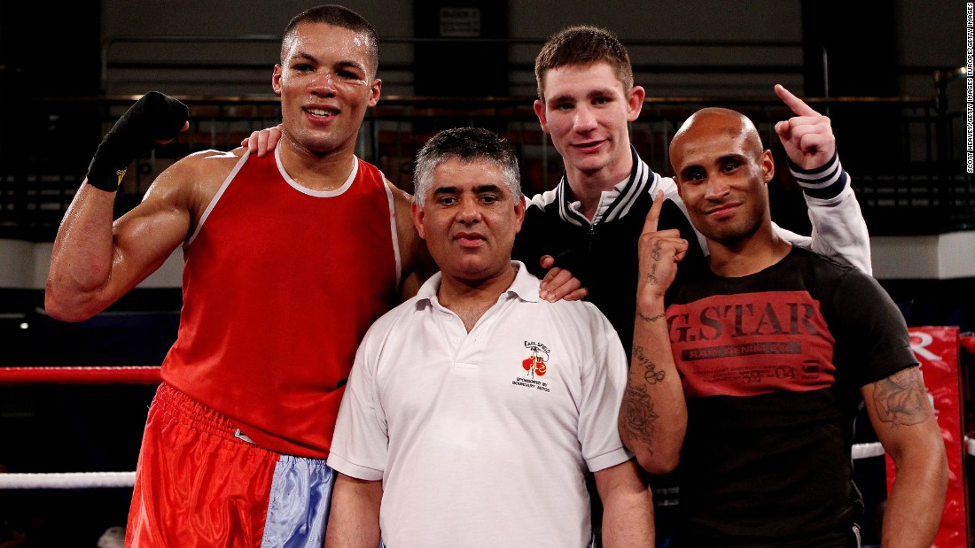Khan (middle) is flanked by winning fighters Joe Joyce (L), Kirk Garvey (C) and Louis Adolphe (R) after a victorious night for Earlsfield at the 2012 ABA Elite Championship Finals at York Hall in east London. 
