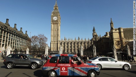 LONDON, ENGLAND - MARCH 26:  A taxi with a Union Flag livery drives through Parliament Square on March 26, 2012 in London, England.  (Photo by Oli Scarff/Getty Images)