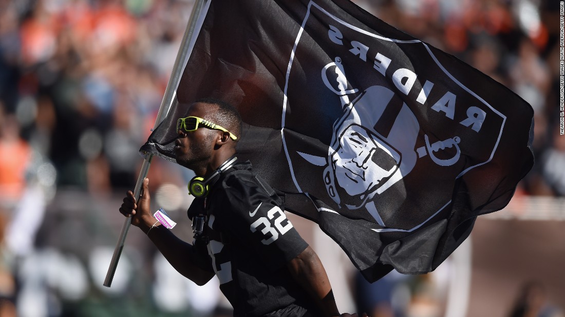 Leeper carries the Oakland Raiders flag in a break in play against the Denver Broncos in November 2014.