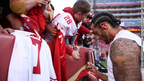 Kaepernick signs an autograph for a fan prior to playing the Los Angeles Rams in their NFL game at Levi&#39;s Stadium.