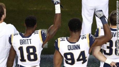 LA Rams&#39; Kenny Britt and Robert Quinn raise their fists in protest prior to their game against the San Francisco 49ers.