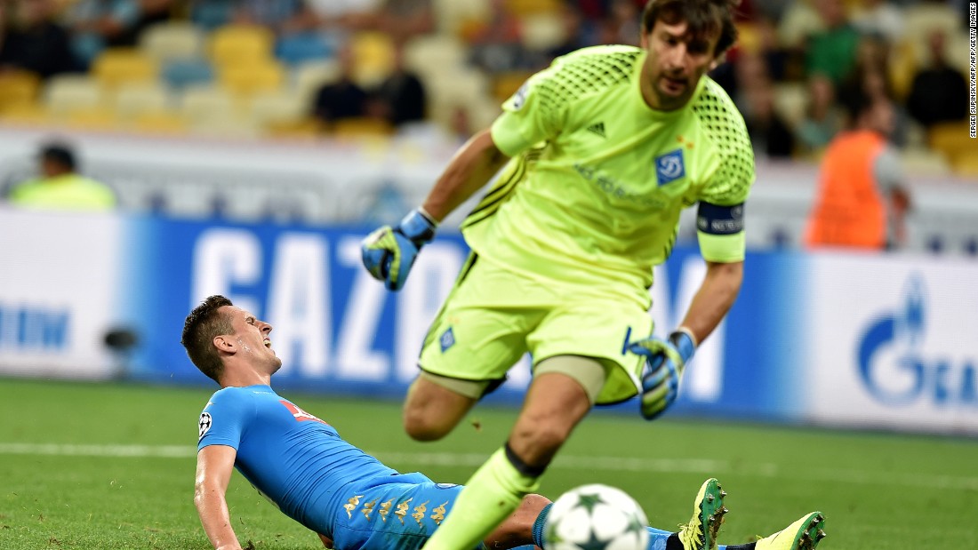 Dynamo Kiev goalkeeper Olexandr Shovkovskiy made history by becoming the second oldest player to contest a Champions League match but he was beaten twice by Arkadiusz Milik, pictured on the floor, as Napoli won 2-1. 