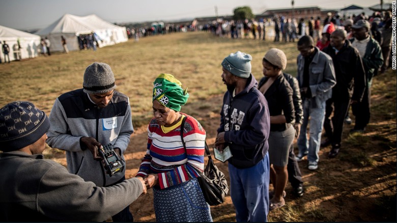 South African voters having their ID checked digitally at a polling station