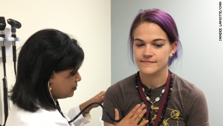 Dr. Sri Edupuganti does a physical exam of vaccine volunteer Virginia Bliss.