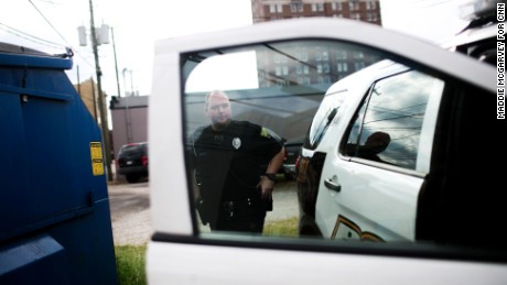 Patrolman Jacob Felix prepares to go out on a call. More than 50% of his job, he says, is responding to heroin overdoses.