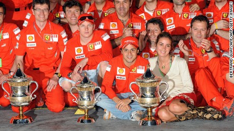 Felipe Massa poses with wife Anna Rafaela and Ferrari staff after winning the 2008 GP in Bahrain. 