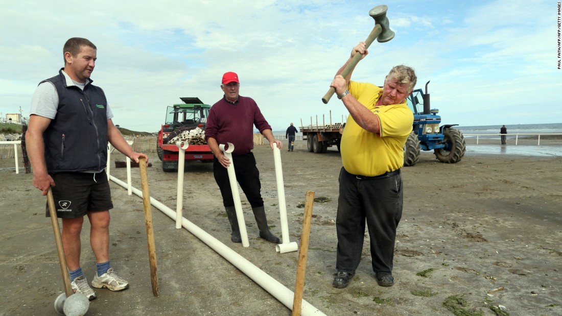 Men work to erect the temporary race course on Laytown beach.