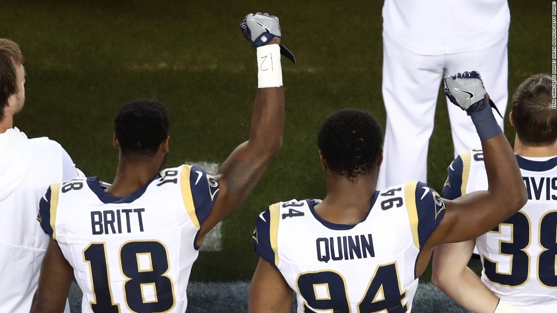 Kenny Britt and Robert Quinn of the Los Angeles Rams raise their fists prior to playing the San Francisco 49ers on September 12, 2016, in Santa Clara.