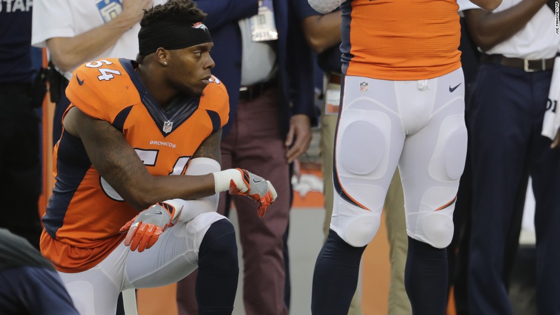 Denver Broncos&#39; Brandon Marshall  kneels on the sideline during the national anthem before a game against the Carolina Panthers in Denver on September 8, 2016.