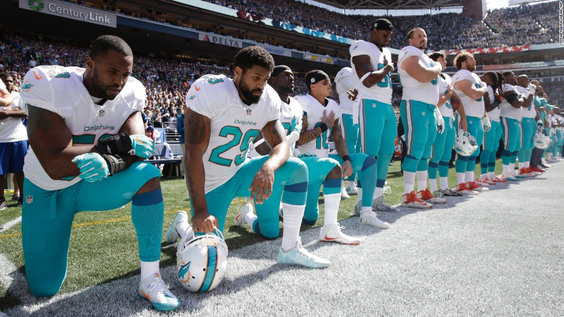 From left, Miami Dolphins&#39; Jelani Jenkins, Arian Foster, Michael Thomas and Kenny Stills kneel during the singing of the national anthem before a game against the Seattle Seahawks on September 11, 2016.