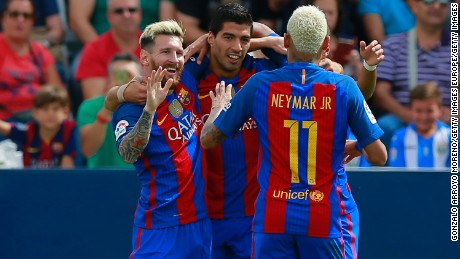 Lionel Messi celebrates Barcelona&#39;s opening goal with Luis Suarez and Neymar.