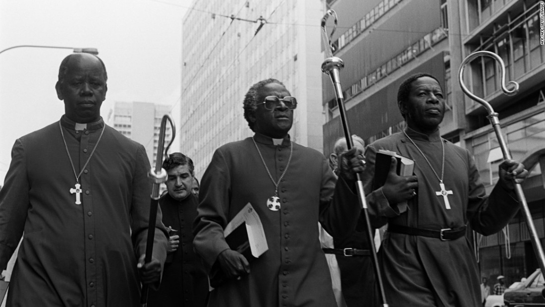 Tutu, center, leads clergymen through Johannesburg in April 1985. They were heading to police headquarters to hand a petition calling for the release of political detainees. 