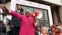 CAPE TOWN, SOUTH AFRICA:  Archbishop Desmond Tutu joyfully shouts &quot;I am free! We are all free&quot; outside the Civic Centre in Cape Town on 20 May, prior to a ceremony where he received the  Freedom of the City.  Hundreds of Capetonians joined in a &quot;March for the Arch&quot; through the streets of the city.  He is accompanied by Theresa Solomon (bottom 2nd R), Mayor of the city, and singer Johnathan Butler(bottom, R). (Photo credit should read ANNA ZIEMINSKI/AFP/Getty Images)