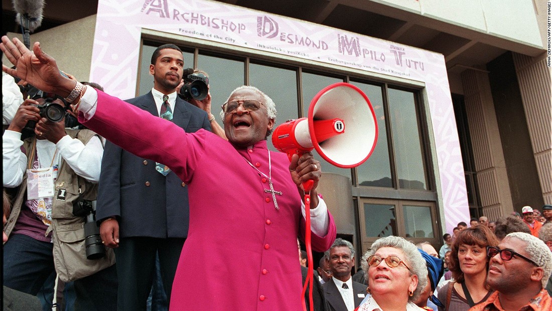 Tutu joyfully shouts &quot;I am free! We are all free!&quot; outside the Civic Centre in Cape Town in 1998. It was before a ceremony where he received the Freedom of the City award. In 1998, Tutu retired as the archbishop of Cape Town and became archbishop emeritus.