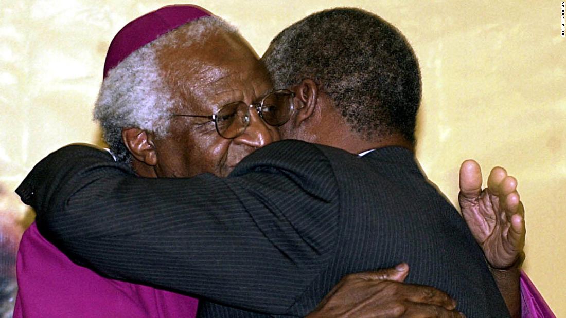 Tutu hugs South African President Thabo Mbeki after turning over the Truth and Reconciliation Report in 2003. Tutu chaired the commission that produced the report.