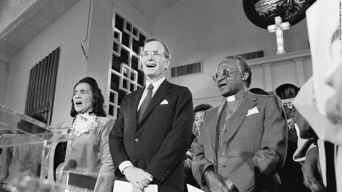 Coretta Scott King, US Vice President George H.W. Bush and Tutu sing the civil rights hymn &quot;We Shall Overcome&quot; during a service honoring Martin Luther King Jr. in January 1986.