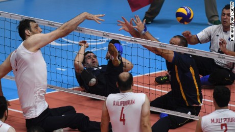 Morteza Mehrzadselakjani (L) of Iran competes during the sitting volleyball gold medal match between Iran and Bosnia and Herzegovina.