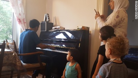 Aeham plays for his neighbours and kids at his new home in Wiesbaden, Germany.