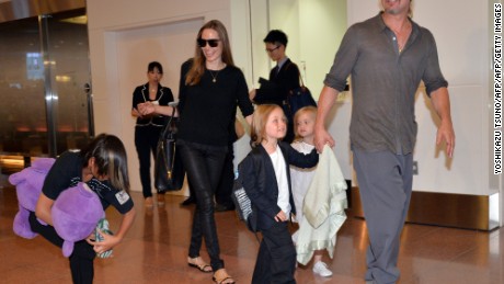 US film stars Brad Pitt (R) and Angelina Jolie (2nd L), accompanied by their children, arrive at Haneda International Airport in Tokyo on July 28, 2013.  Pitt is now here for the promotion of his latest movie &quot;World War Z&quot;.     AFP PHOTO / Yoshikazu TSUNO        (Photo credit should read YOSHIKAZU TSUNO/AFP/Getty Images)