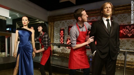 Studio assistants Alex Cameron and Olivia Steen move apart the wax figures of Brad Pitt and Angelina Jolie at Madame Tussauds London following the news of their divorce on Wednesday September 21, 2016.