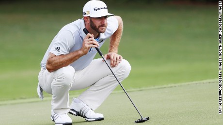 Eyes on the prize: Dustin Johnson lines up a putt at the Tour Championship Thursday.