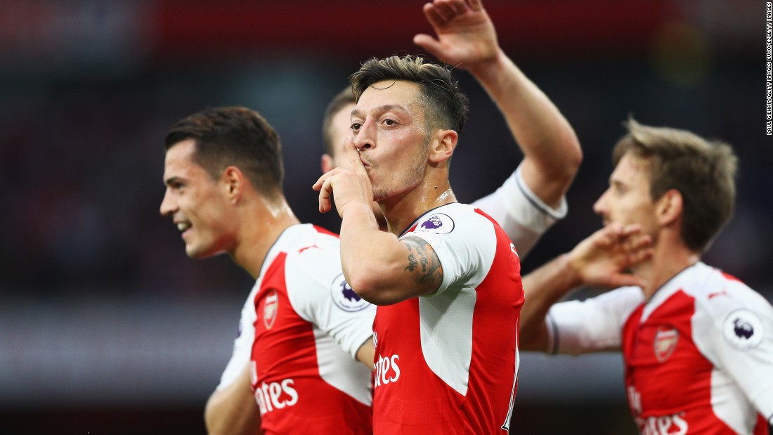 Mesut Ozil of Arsenal (C) celebrates scoring his side&#39;s third goal with teammates during the Premier League match between Arsenal and Chelsea at the Emirates Stadium. 