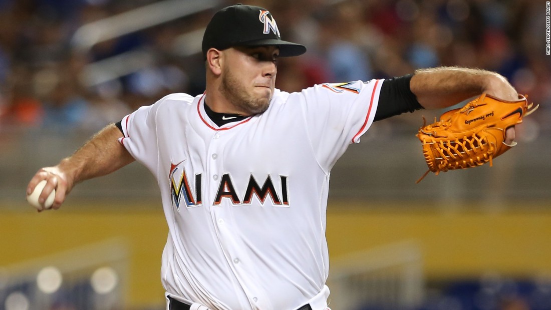 man in marlins jersey at baseball games