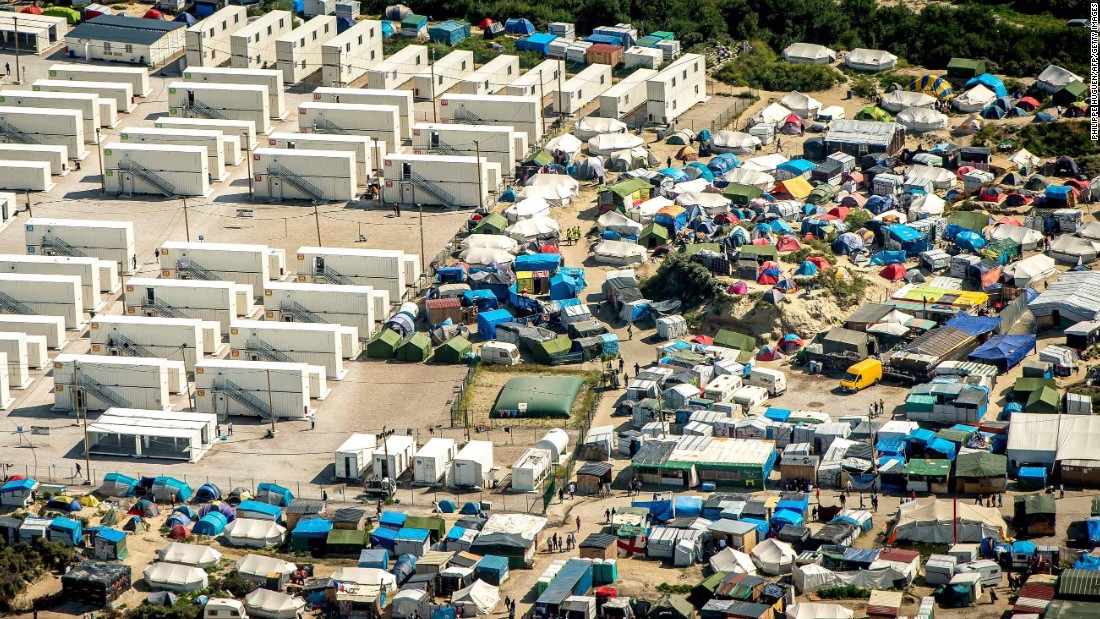 This aerial view taken Tuesday, August 16, shows the tents and shipping containers housing migrants in &quot;The Jungle.&quot;