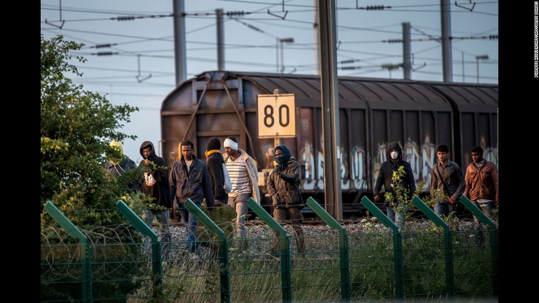 Several migrants successfully cross the Eurotunnel terminal in July 2015 as they try to reach a shuttle to the UK.