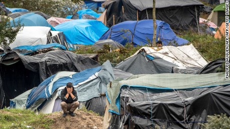 A picture taken  in Calais on October 7, 2015 shows a site dubbed the &quot;New Jungle&quot;, where some 3,000 people have set up camp -- most seeking desperately to get to England, . The slum-like migrant camp sprung up after the closure of notorious Red Cross camp Sangatte in 2002, which had become overcrowded and prone to violent riots. However migrants and refugees have kept coming and the &quot;New Jungle&quot; has swelled along with the numbers of those making  often deadly attempts to smuggle themselves across the Channel.  AFP PHOTO / PHILIPPE HUGUEN        (Photo credit should read PHILIPPE HUGUEN/AFP/Getty Images)