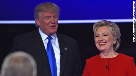 Hillary Clinton and Donald Trump shake hands following the first presidential debate moderated by NBC host Lester Holt(bottom L) at Hofstra University in Hempstead, New York on September 26, 2016. 