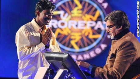 Sushil Kumar, 27, (L) gestures as he receives his one million USD prize from Bachchan during the fifth season of the Indian version of &quot;Who Wants to be a Millionaire?&quot; 