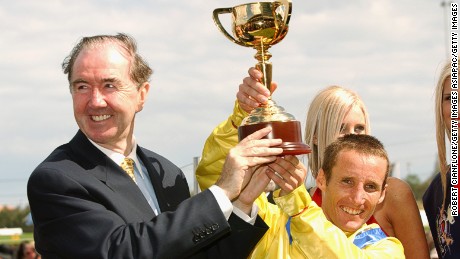 Dermot Weld and jockey Damien Oliver celebrate their 2002 Melbourne Cup victory.