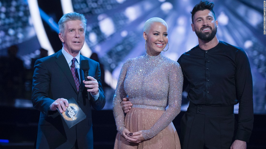 &quot;Dancing with the Stars&quot; contestant Amber Rose said she felt body shamed by judge Julianne Hough during her week 3 performance. Rose is shown here with co-host Tom Bergeron and partner Maksim Chmerkovskiy.