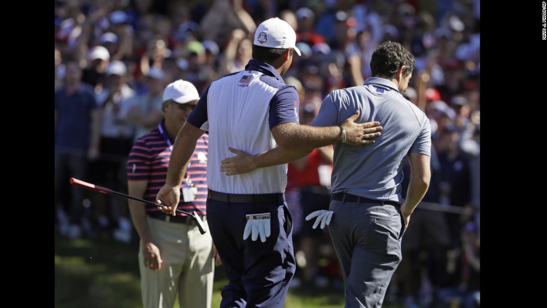 United States&#39; Patrick Reed and Europe&#39;s Rory McIlroy walk off the eighth hole together during a singles match.