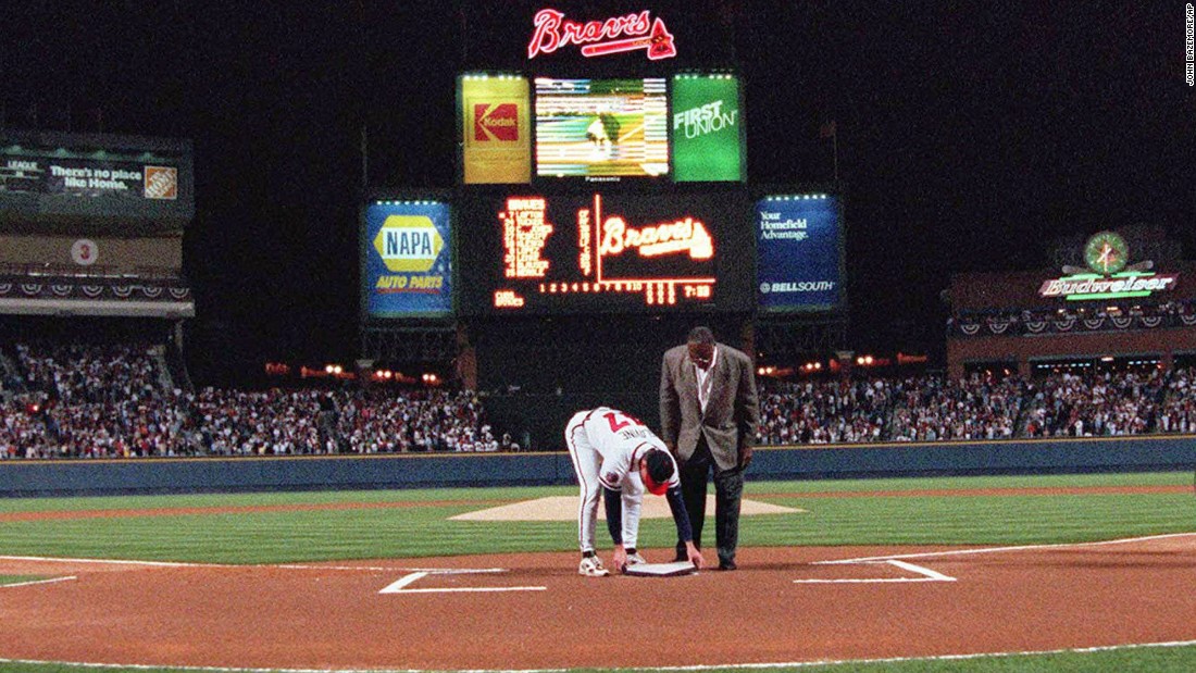 Former Atlanta Braves great Hank Aaron looks on as pitcher Tom Glavine puts home plate from Atlanta Fulton County Stadium on top of the plate at Turner Field before the Braves opened their new home against the Chicago Cubs on Friday, April 4, 1997.