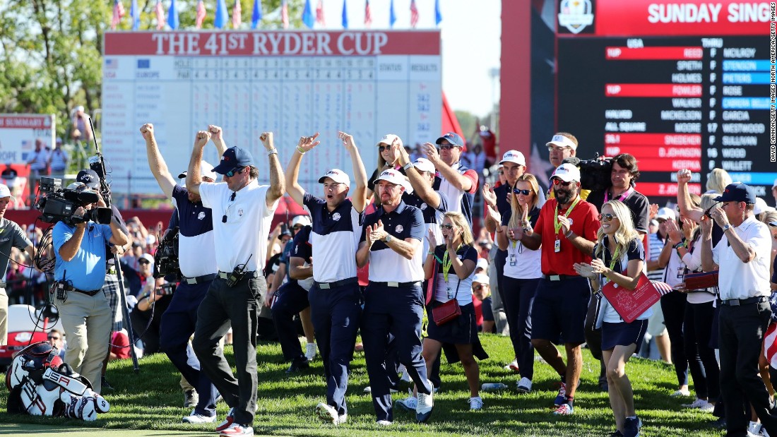 US players celebrate on the 18th green as their team closed out victory over Europe.