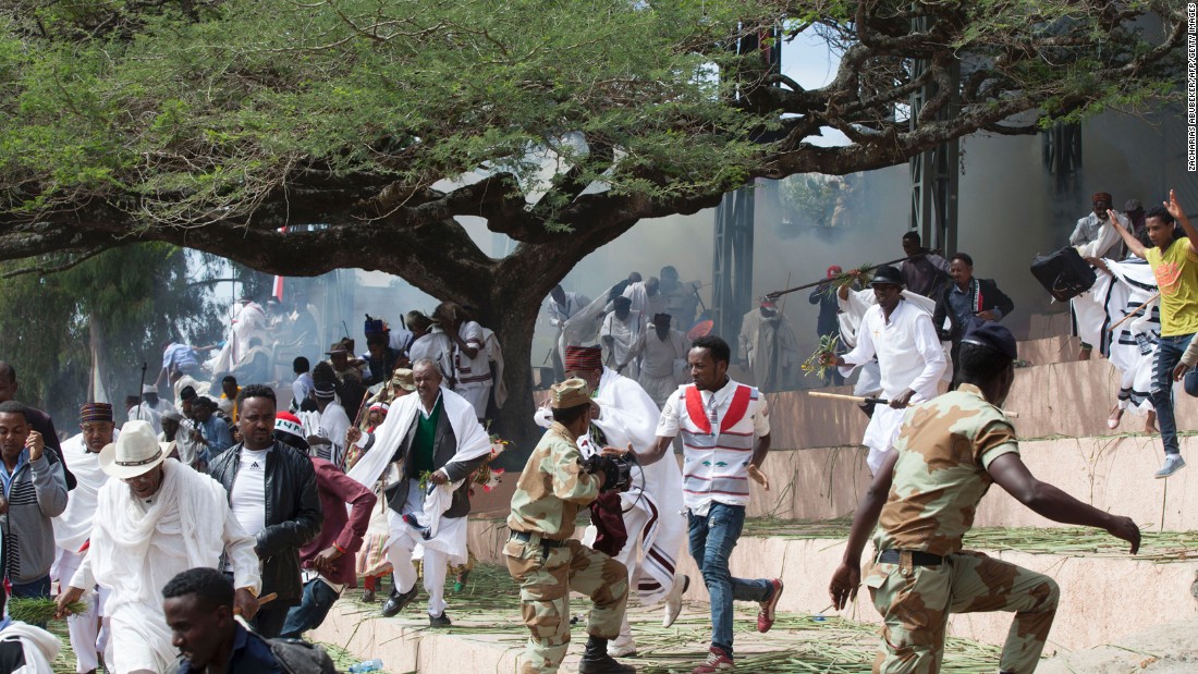 Festival goers flee as police fire teargas into the crowd in Bishoftu, near Addis Ababa, Ethiopia, on Sunday, October 2. At least 52 people died during the stampede that followed. An estimated two million people had gathered at a sacred lake to take part in the Irreecha ceremony to mark the Oromo New Year.