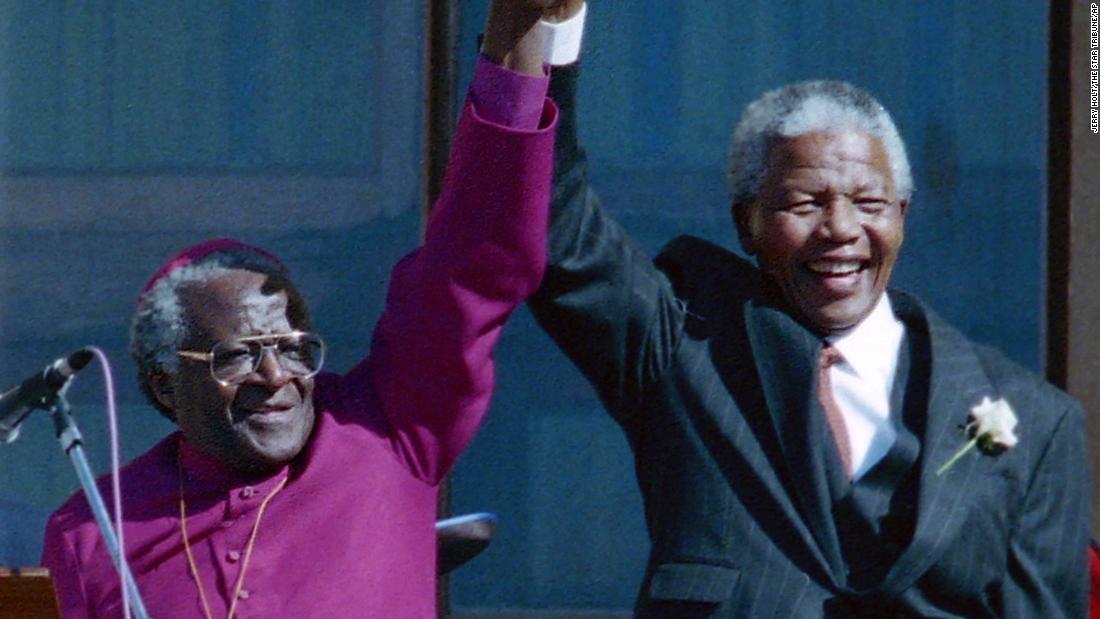 Tutu stands with Mandela after Mandela was elected president in 1994.