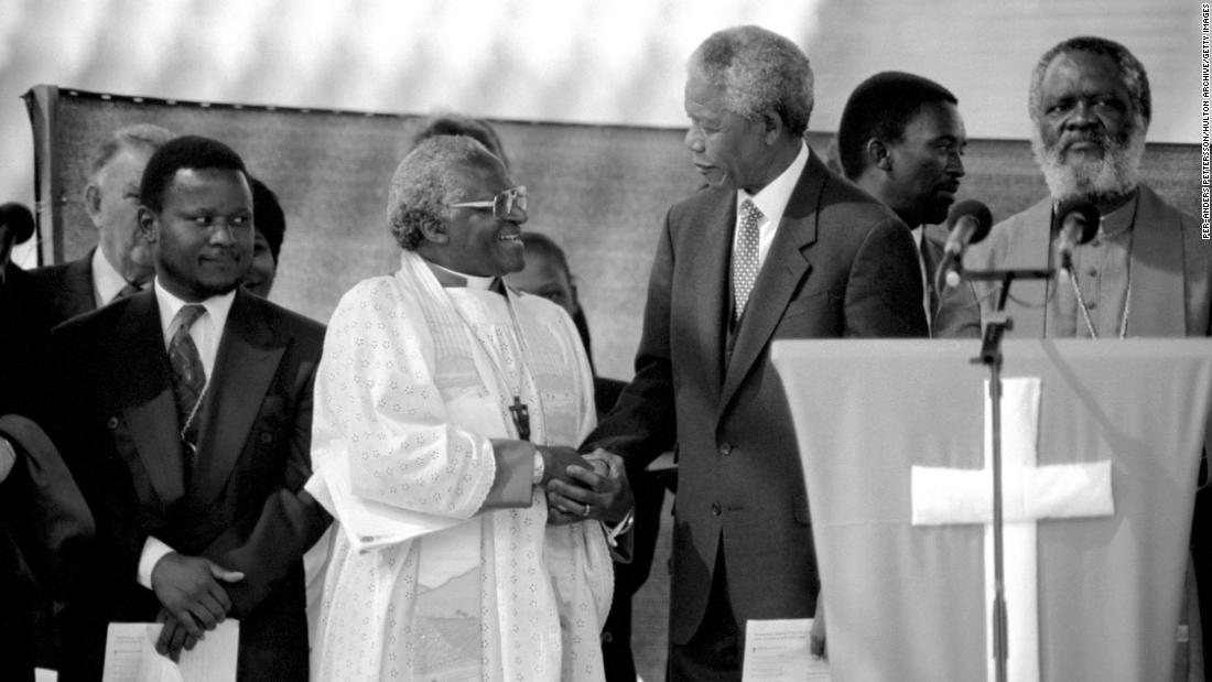 Tutu greets Mandela at a rally, weeks before South Africa&#39;s historic democratic election in 1994.