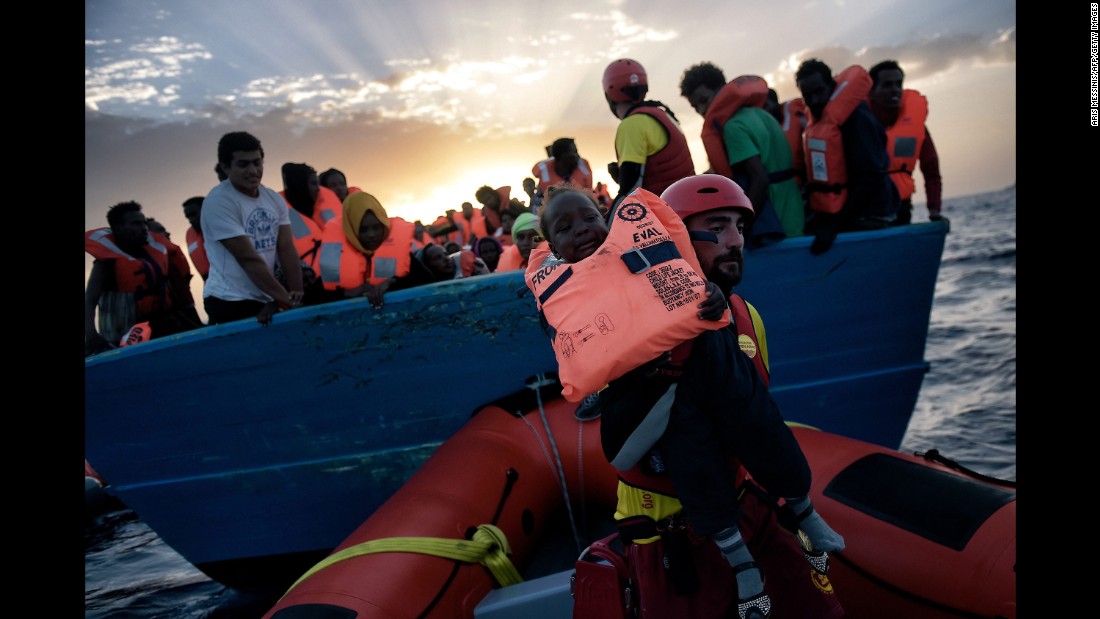 A child is rescued by a member of Proactiva Open Arms.
