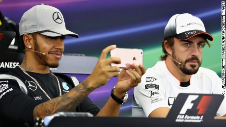 Lewis Hamilton plays with his phone in a press conference ahead of the Japan Grand Prix in Suzuka.