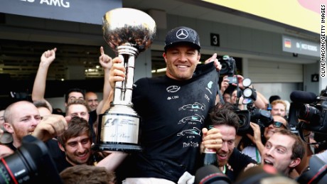 Nico Rosberg celebrates his victory at Suzuka with his Mercedes team which has sealed the Constructors&#39; crown. 